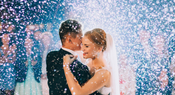 a bride and groom surrounded by their bridesmaids and groomsmen